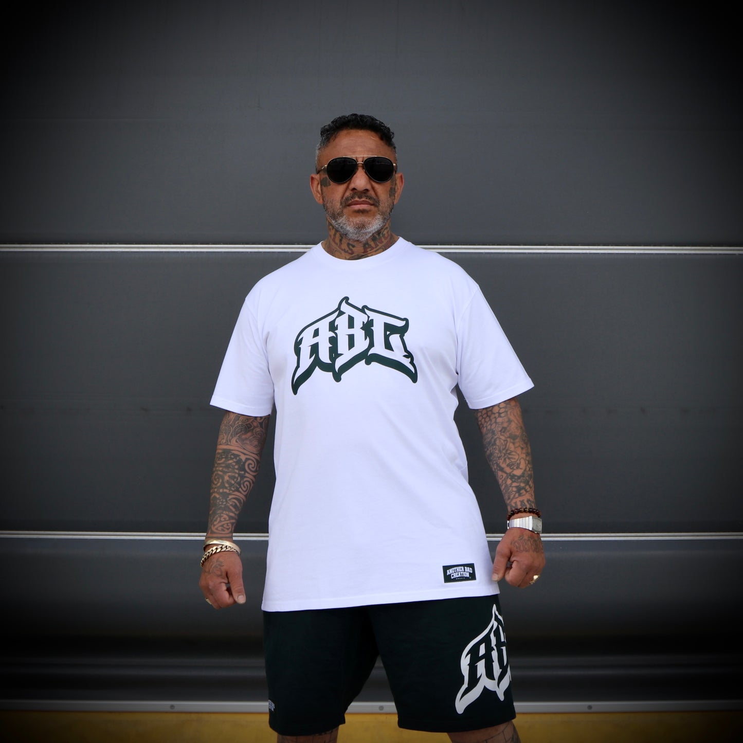 MENS ANOTHER BAD CREATION - WHITE TEE -PRISON PINE GREEN PRINT - LAST STOCK